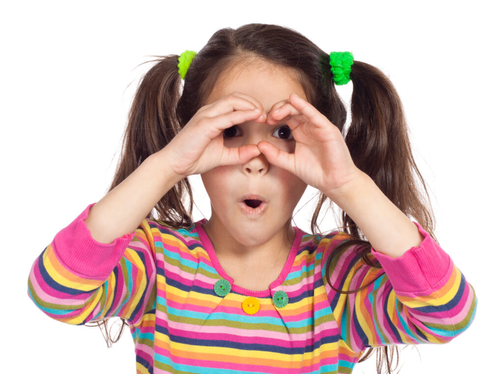 Little girl looking through imaginary binocular, isolated on white